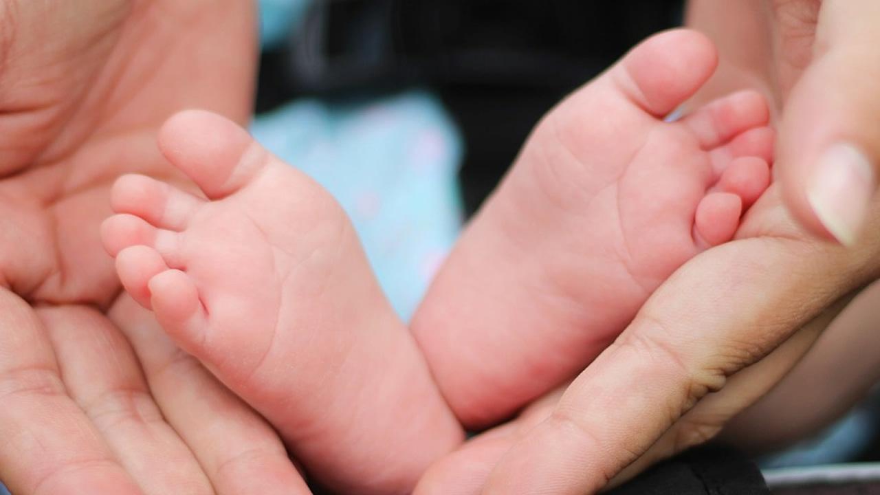 baby feet in adult hands